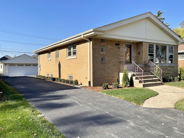 view of front of house featuring a garage and an outdoor structure