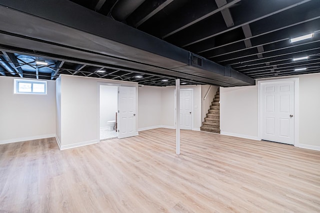 basement with light hardwood / wood-style floors