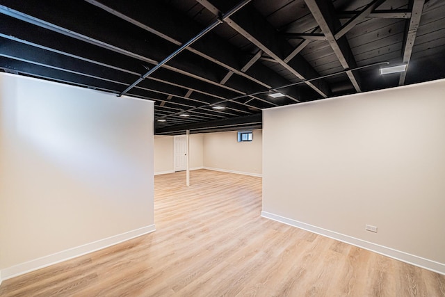 basement with hardwood / wood-style flooring