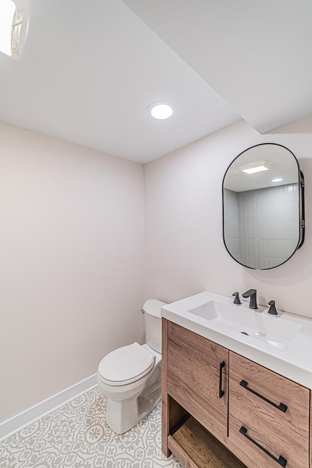 bathroom featuring vanity, tile patterned floors, and toilet