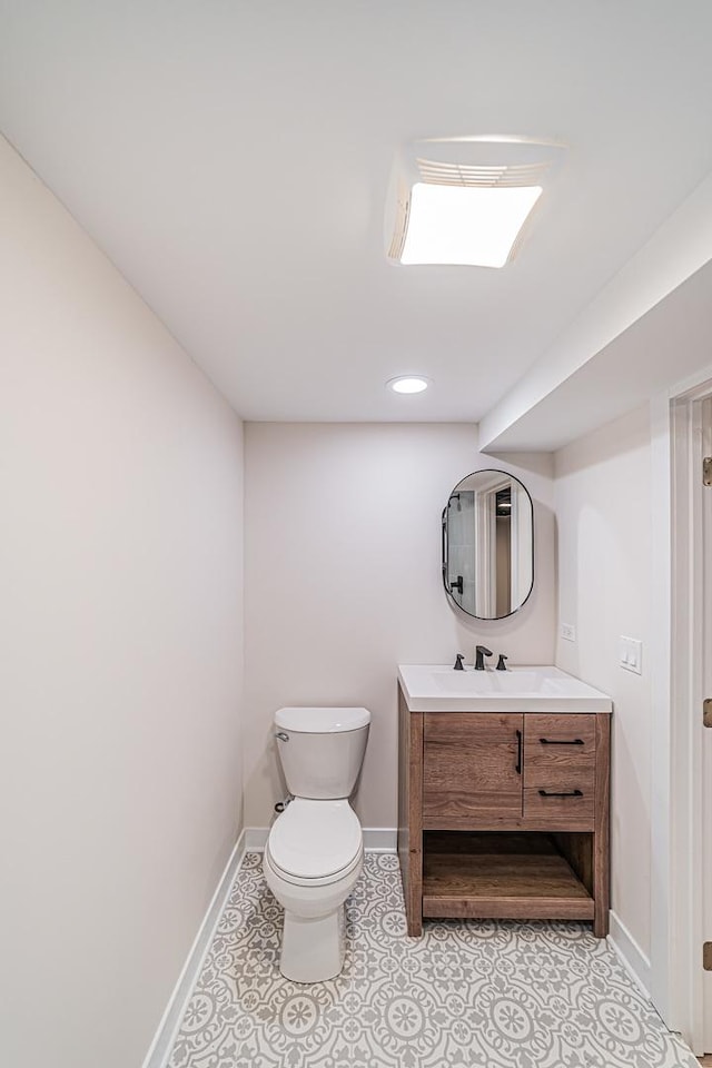 bathroom featuring tile patterned flooring, vanity, and toilet