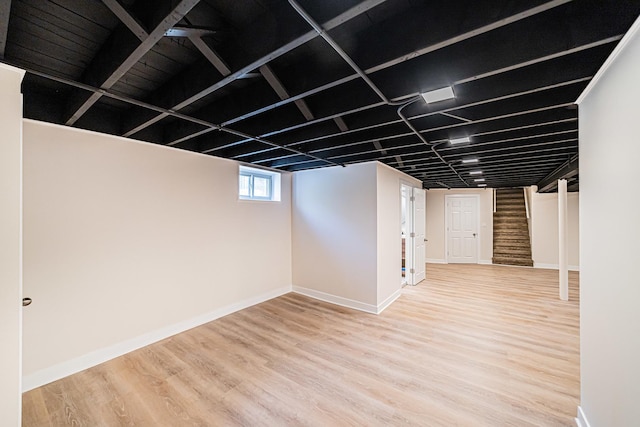 basement with hardwood / wood-style flooring