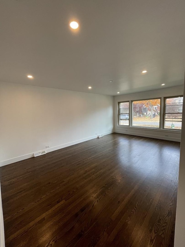 empty room featuring dark wood-type flooring