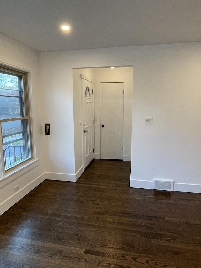 empty room with dark hardwood / wood-style floors