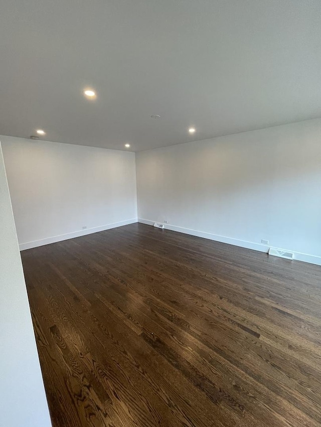 spare room with dark hardwood / wood-style floors