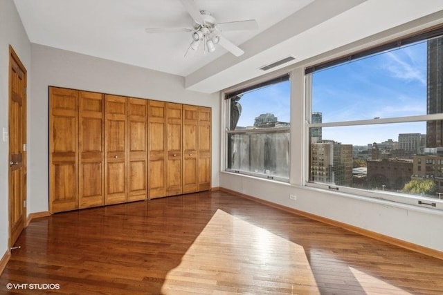 unfurnished bedroom featuring ceiling fan and dark hardwood / wood-style flooring