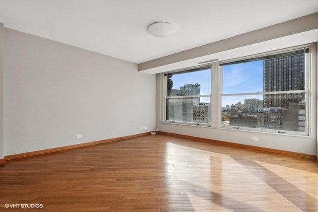 unfurnished room with hardwood / wood-style floors