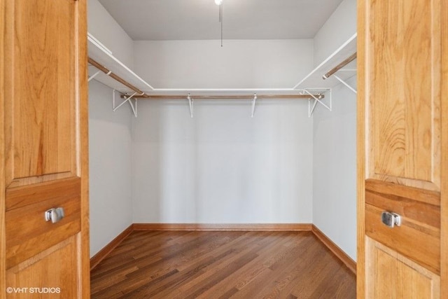 spacious closet with dark hardwood / wood-style floors