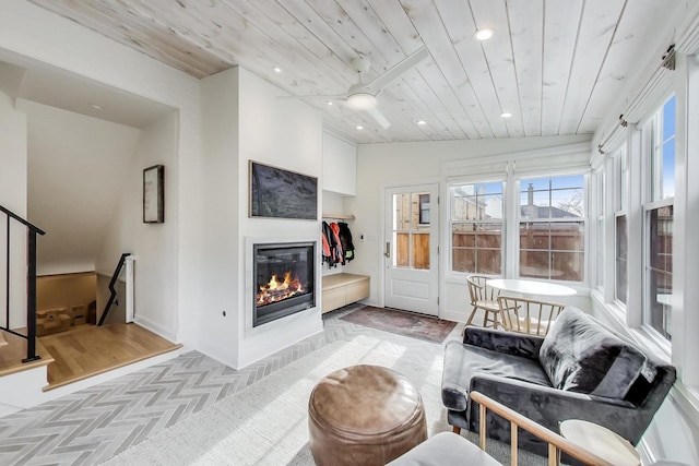 living room featuring wood ceiling and light parquet floors