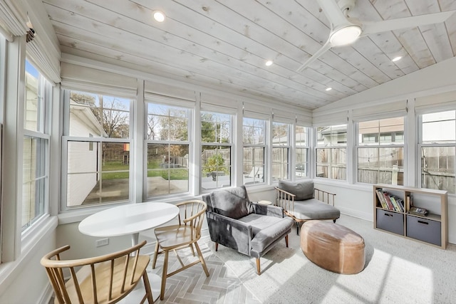 sunroom with vaulted ceiling, wooden ceiling, and plenty of natural light