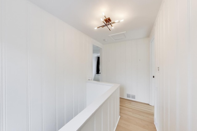 corridor with light hardwood / wood-style floors