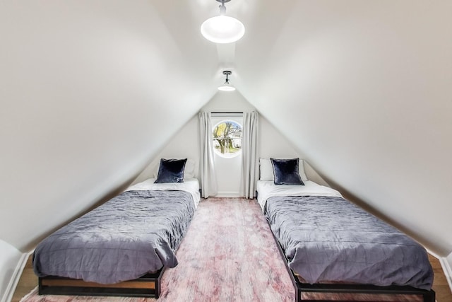 bedroom with carpet and lofted ceiling