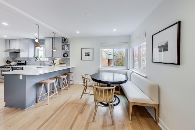 dining room with light wood-type flooring and sink