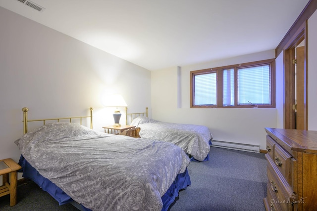 bedroom with carpet flooring and a baseboard heating unit