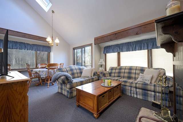 carpeted living room with a skylight, high vaulted ceiling, and an inviting chandelier