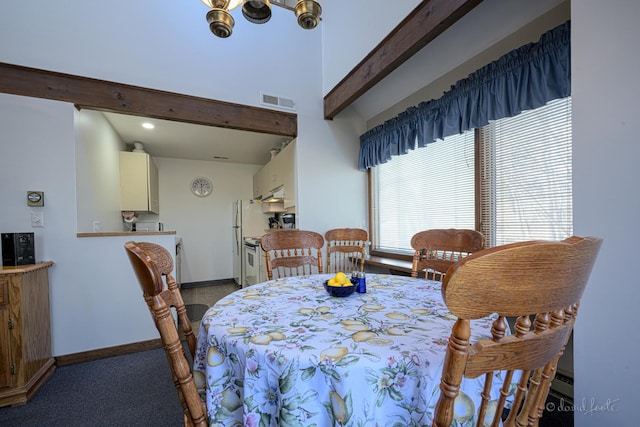 dining room featuring beam ceiling and carpet floors