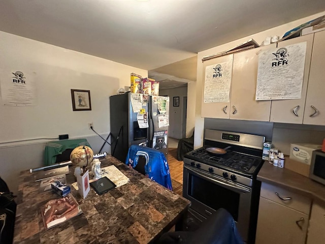 kitchen with stainless steel appliances and hardwood / wood-style flooring