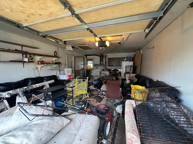 garage with white fridge and a garage door opener