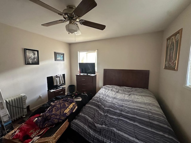 bedroom with ceiling fan and radiator