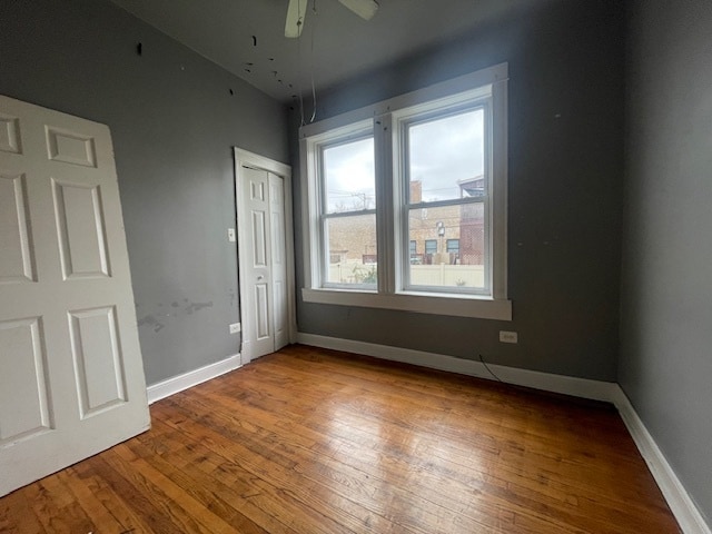 unfurnished bedroom featuring hardwood / wood-style flooring and ceiling fan