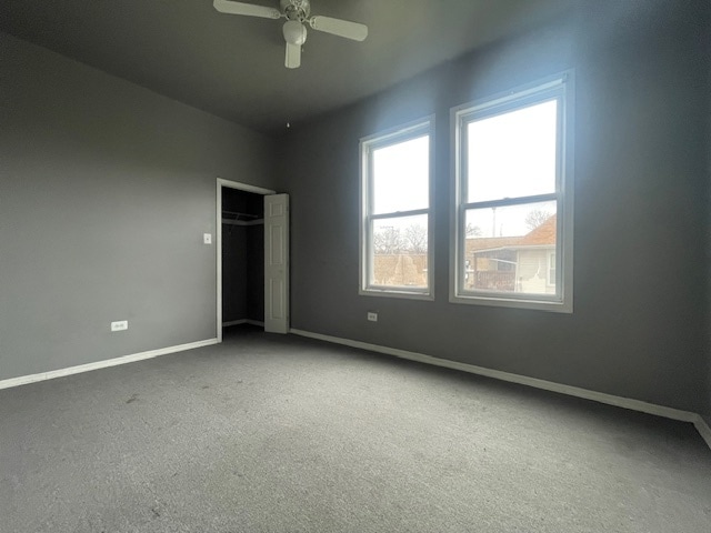 unfurnished bedroom with ceiling fan, a closet, and carpet floors