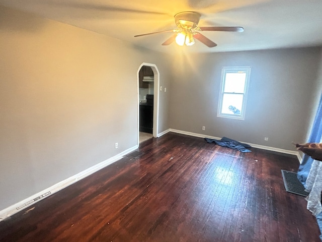 unfurnished room with dark hardwood / wood-style floors and ceiling fan