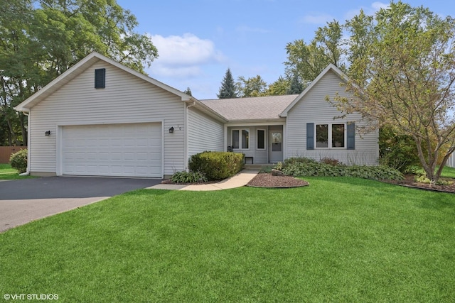 ranch-style house featuring a garage and a front yard