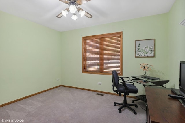 carpeted home office with ceiling fan