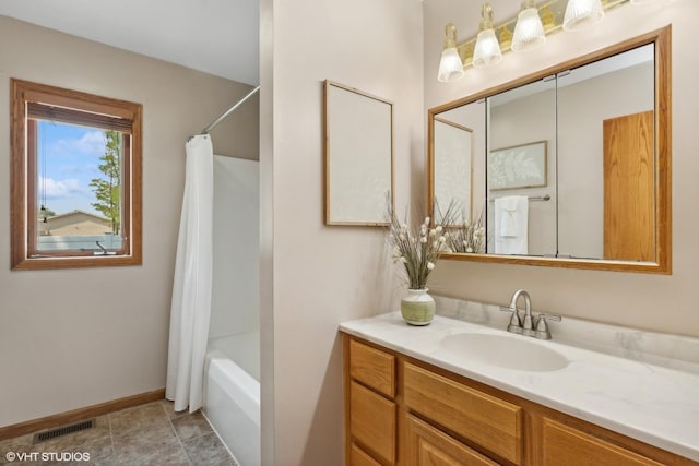 bathroom with vanity, tile patterned flooring, and shower / bath combo with shower curtain