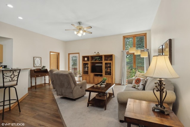 living room with hardwood / wood-style flooring and ceiling fan