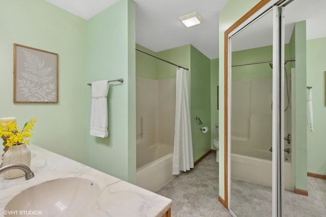 bathroom with tile patterned flooring, vanity, and toilet