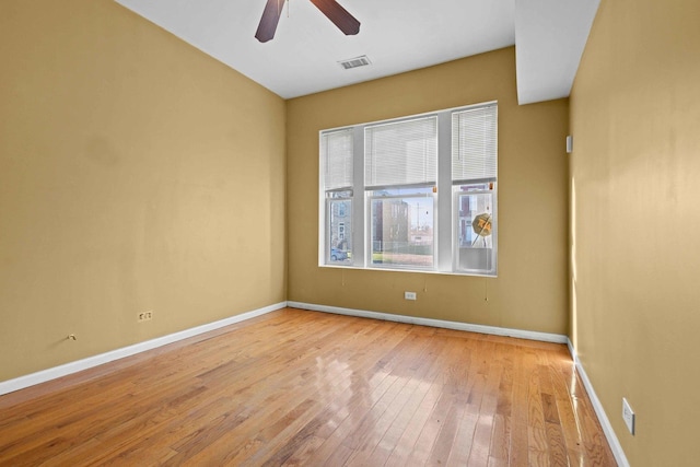 spare room with light wood-type flooring and ceiling fan