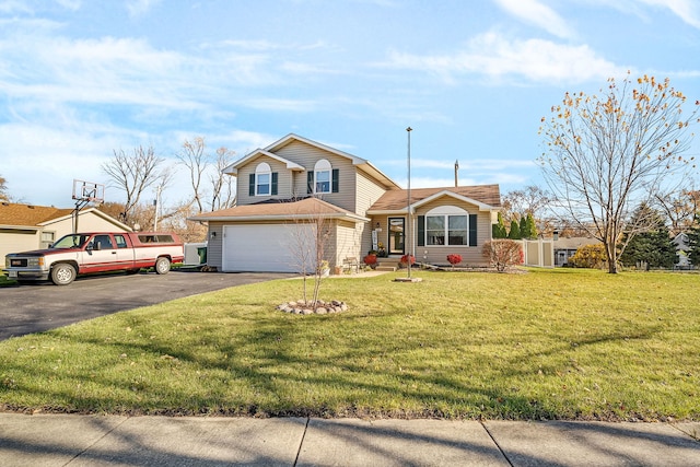 view of front of home with a garage and a front lawn