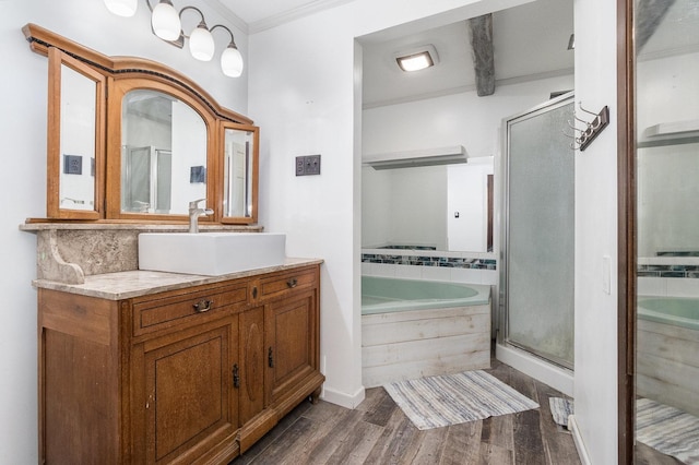 bathroom with vanity, crown molding, plus walk in shower, and hardwood / wood-style flooring