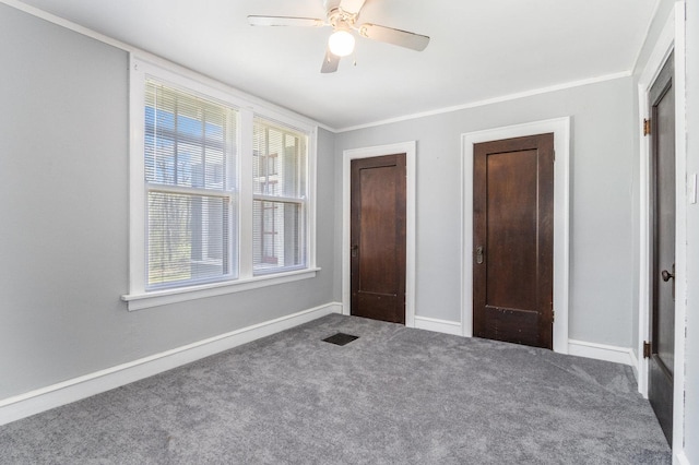 unfurnished bedroom featuring carpet, ceiling fan, and ornamental molding