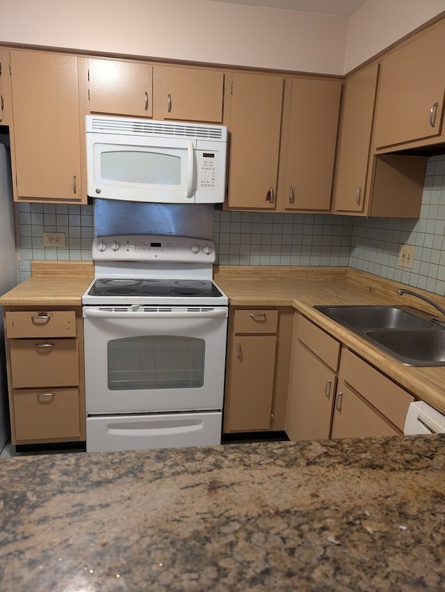 kitchen featuring tasteful backsplash, light brown cabinetry, sink, and white appliances