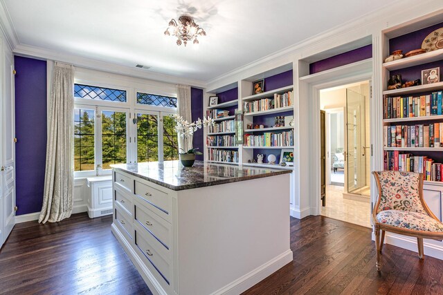 home office with crown molding, built in features, and dark wood-type flooring