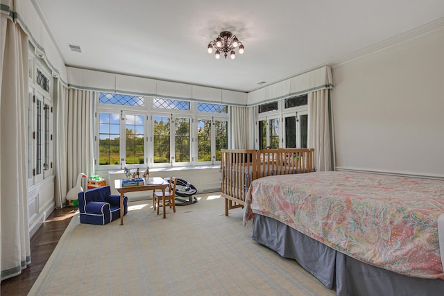 bedroom with a chandelier and ornamental molding