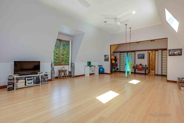 interior space with ceiling fan, light wood-type flooring, and vaulted ceiling