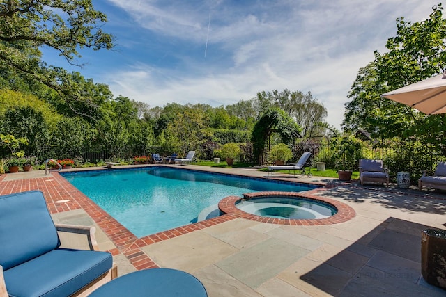 view of pool featuring an in ground hot tub and a patio