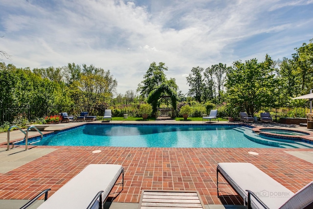 view of swimming pool featuring an in ground hot tub and a patio