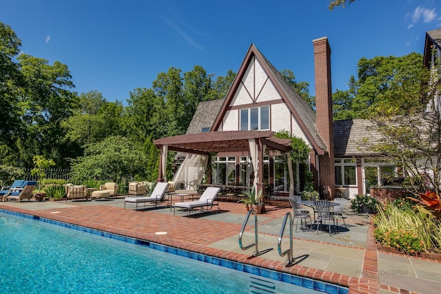 rear view of property with a pergola and a patio