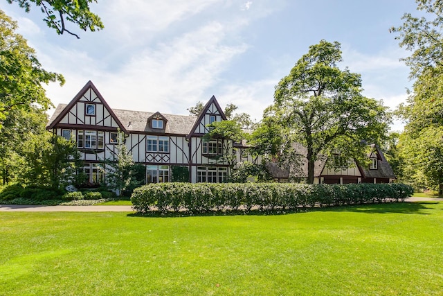 back of house with a lawn