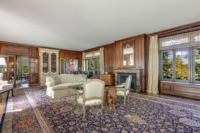 living room with wooden walls and french doors