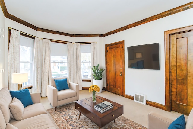 living room featuring light colored carpet, crown molding, and a wealth of natural light