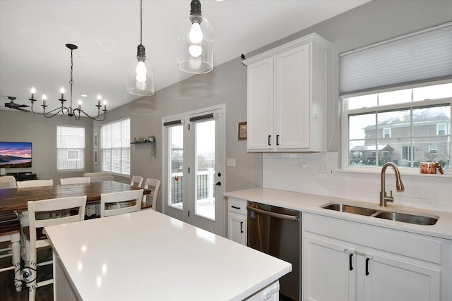 kitchen with dishwasher, decorative backsplash, sink, and a wealth of natural light