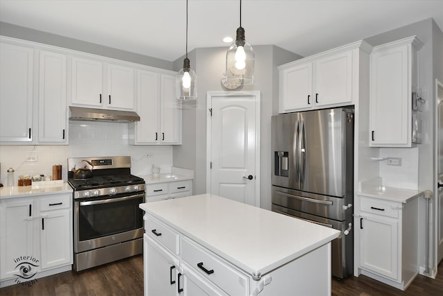 kitchen featuring decorative backsplash, a kitchen island, white cabinetry, and stainless steel appliances