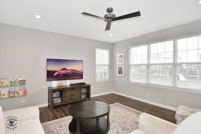 living room with ceiling fan and dark hardwood / wood-style flooring