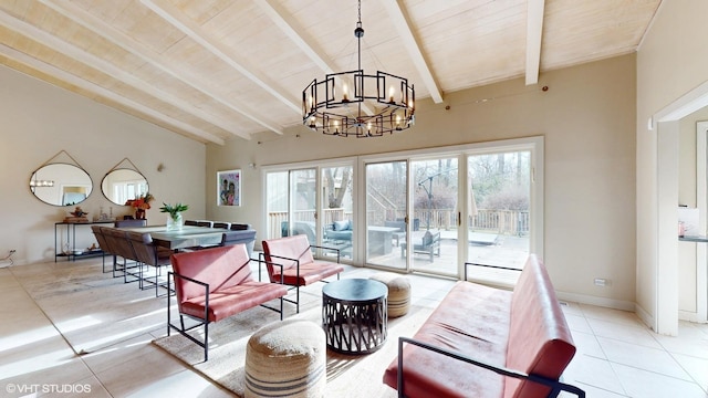 living room featuring a chandelier, light tile patterned floors, plenty of natural light, and beamed ceiling