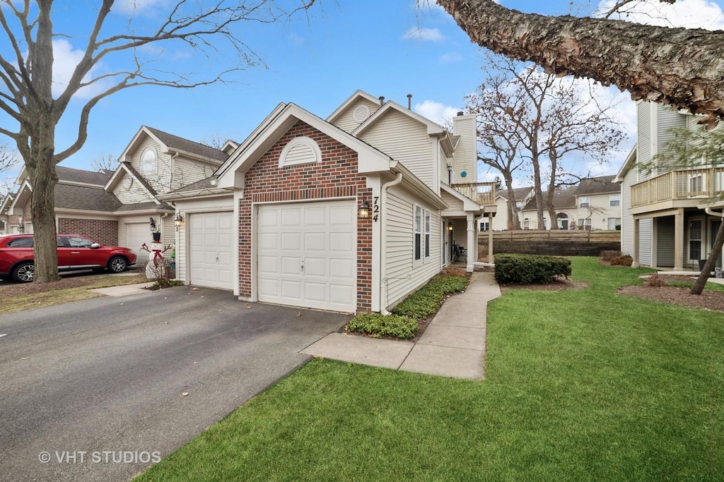 exterior space with a garage and a lawn